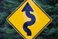 black arrow on yellow background road sign