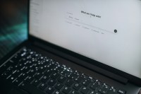 Laptop open with a ChatGPT prompt asking What Can I Help With?